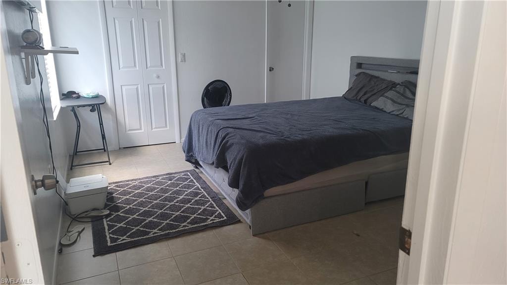 Bedroom featuring a closet and light tile patterned floors