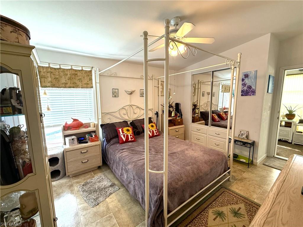 Bedroom with ceiling fan, a closet, and light tile patterned floors