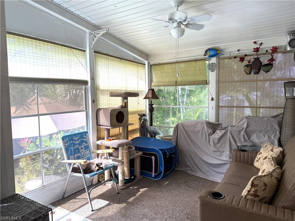 Sunroom featuring a ceiling fan