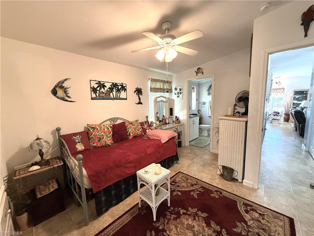 Bedroom with a ceiling fan and ensuite bathroom