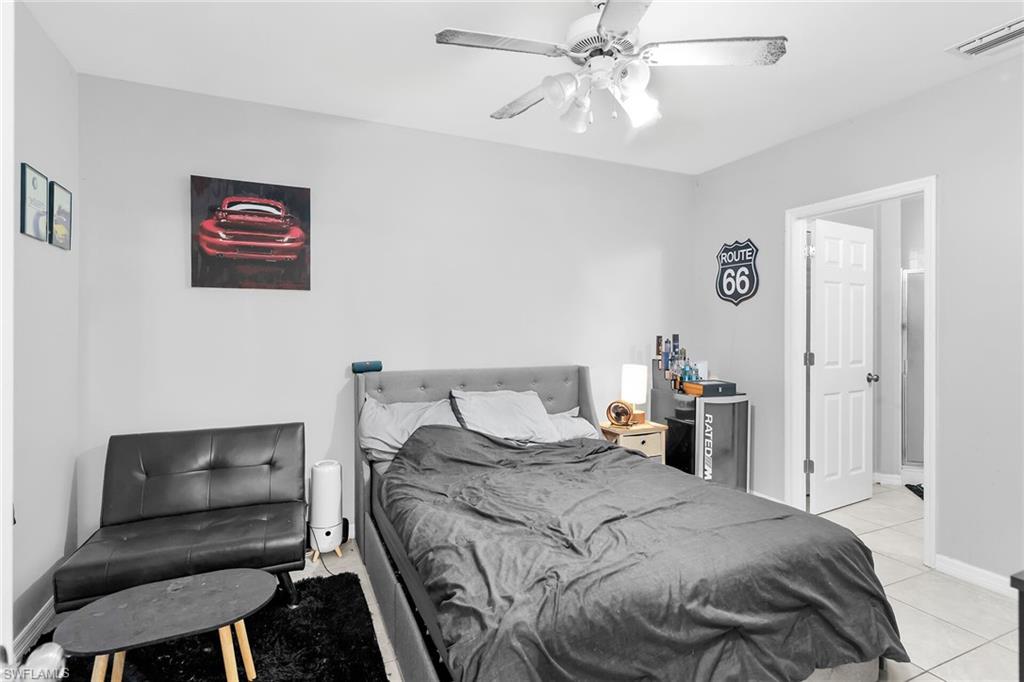 Bedroom with a ceiling fan and light tile patterned floors