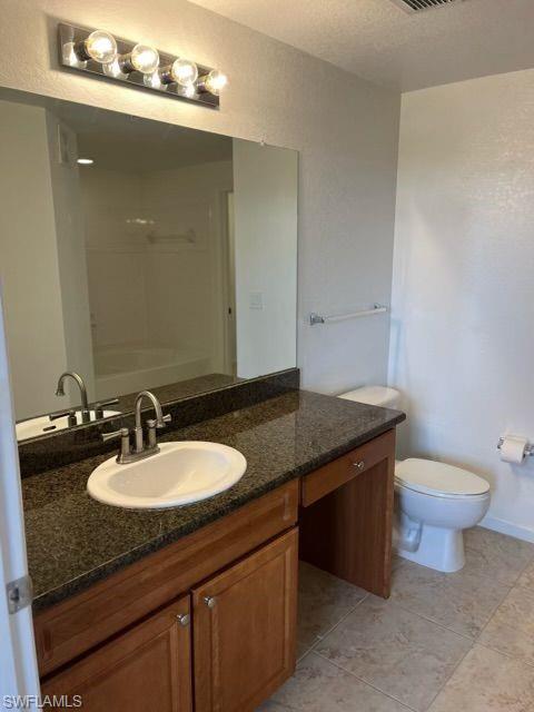 Full bathroom with vanity and light tile patterned floors