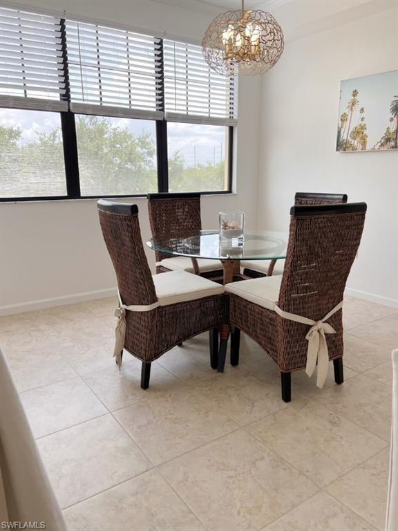 Dining room with a chandelier and light tile patterned floors