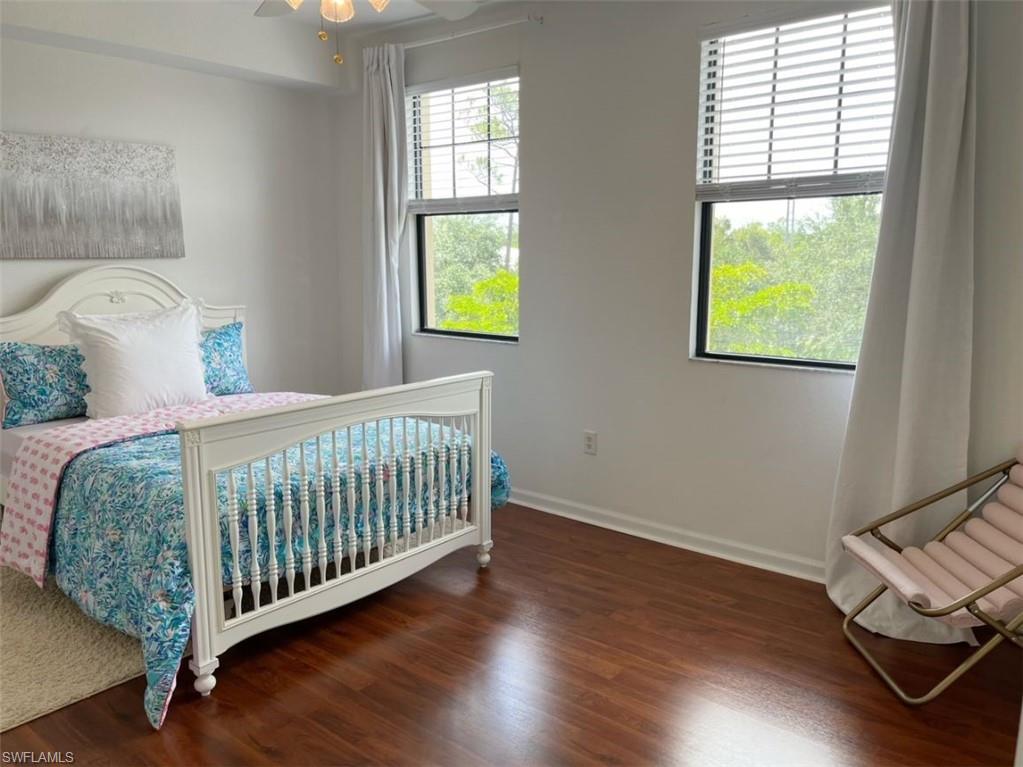 Bedroom with ceiling fan and dark wood-style floors
