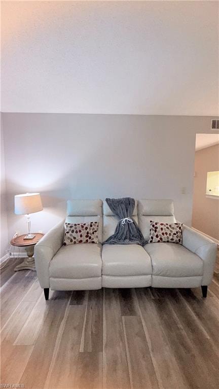 Living area featuring light wood-style floors and baseboards