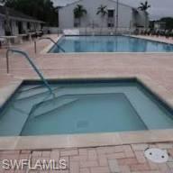 Community pool with a hot tub and a patio area