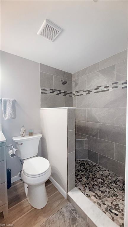 Full bath with a walk in shower, vanity, and light wood-type flooring