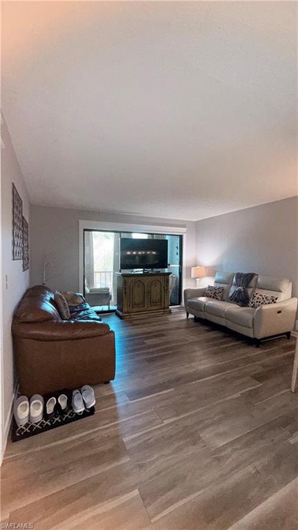 Living area with wood finished floors and baseboards