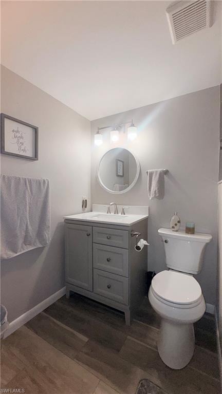 Bathroom featuring vanity and dark wood finished floors
