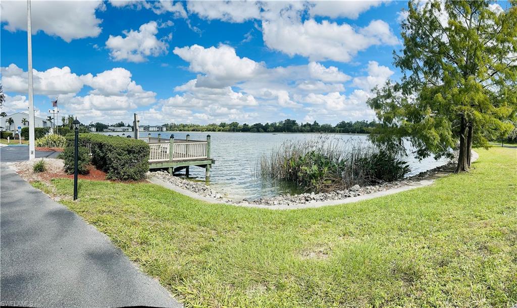 Dock featuring a water view and a yard