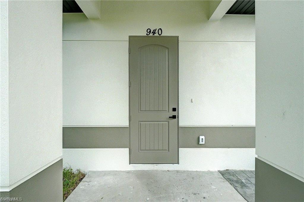 Doorway to property with stucco siding