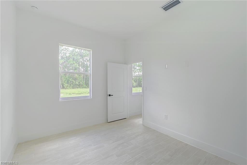 Unfurnished room featuring light wood finished floors and plenty of natural light