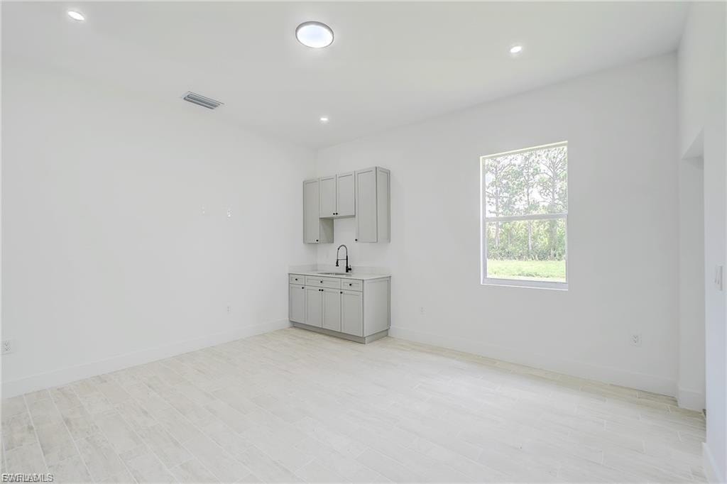 Unfurnished room with light wood finished floors and recessed lighting