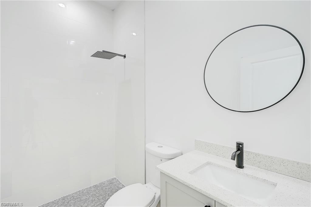 Full bathroom featuring vanity and a tile shower