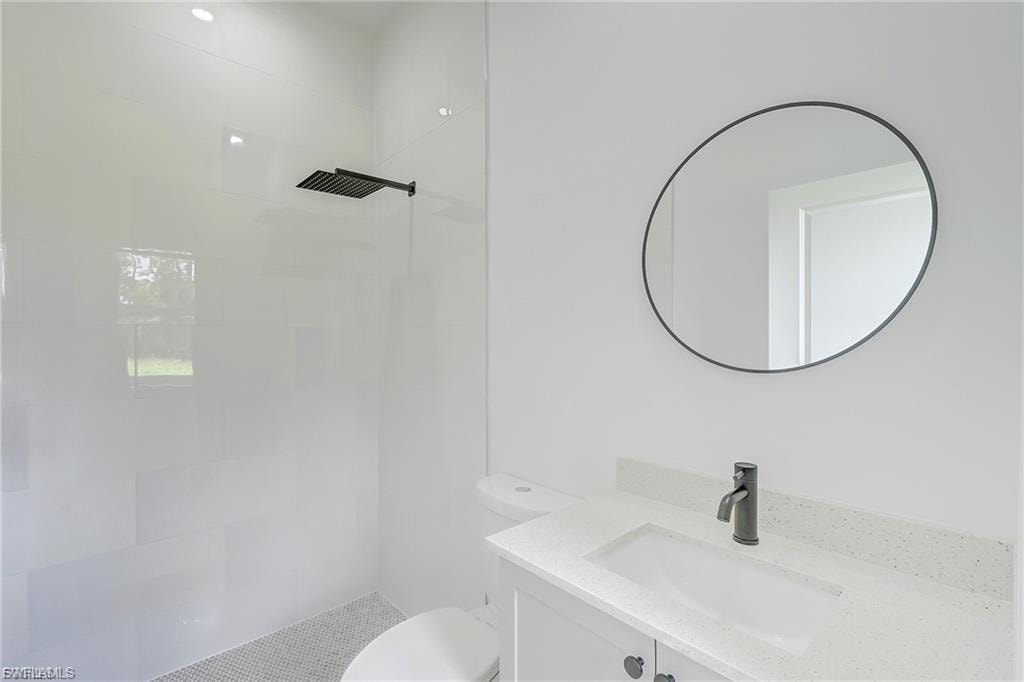 Bathroom featuring vanity and tiled shower