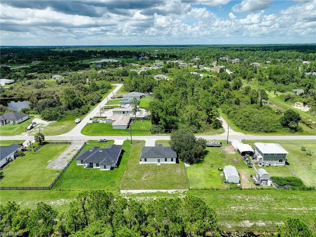 Aerial view of residential area featuring a forest