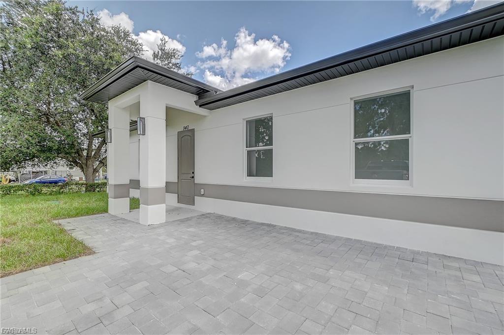 View of home's exterior with stucco siding and a yard