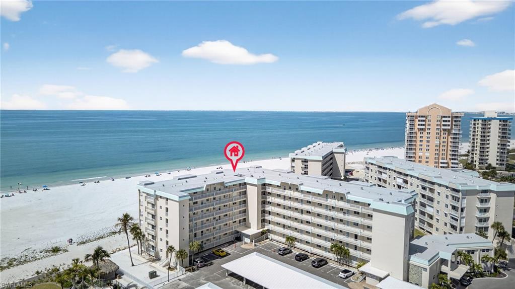 Bird's eye view of apartment complex and extended coastline