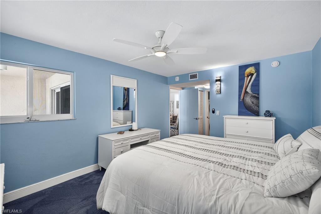 Bedroom featuring dark colored carpet and ceiling fan