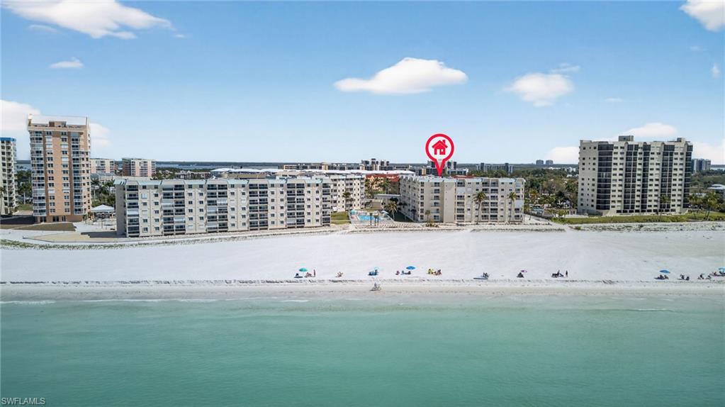 View of urban area featuring apartment complex / building and expansive beach