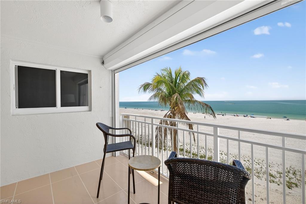 Balcony with view of water and beach