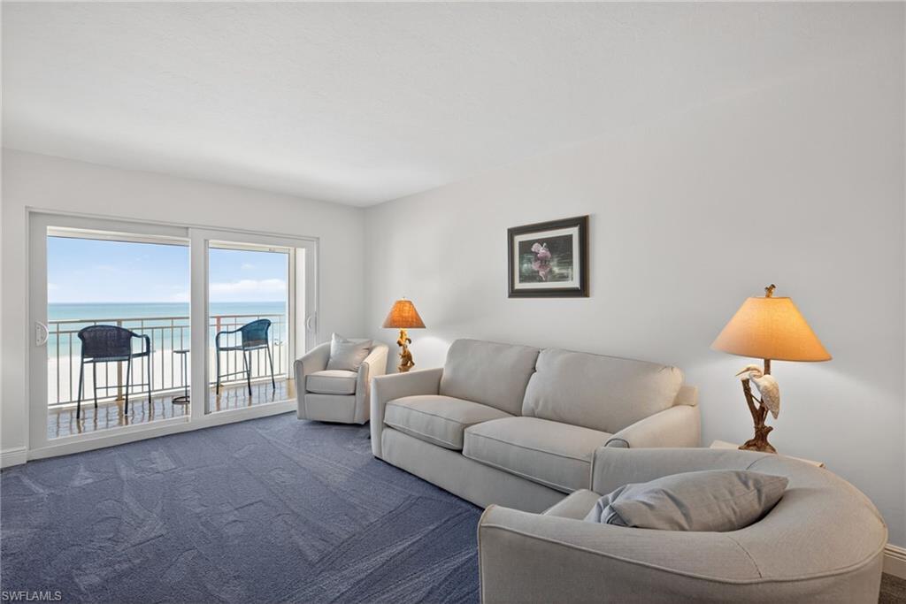 Living area with a water view and carpet floors