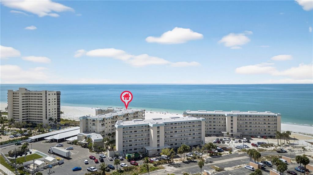 Aerial view of unending shoreline and apartment complex