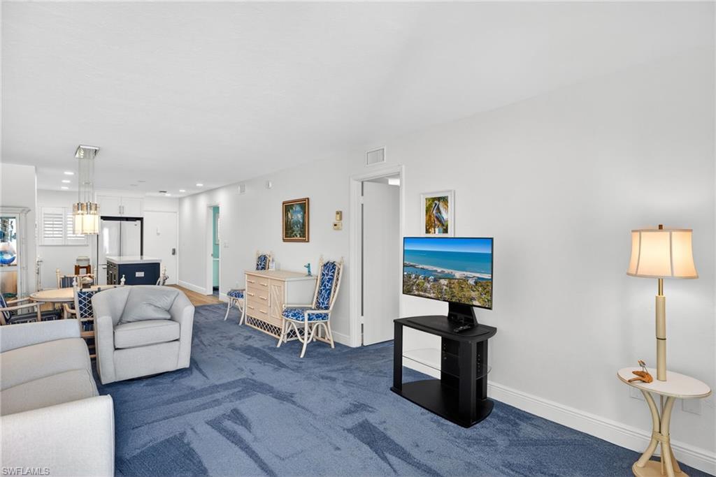 Carpeted living area featuring baseboards and recessed lighting