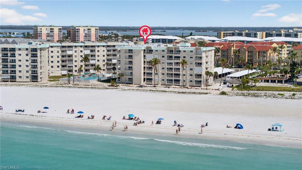 Aerial view of a large body of water and apartment complex / building