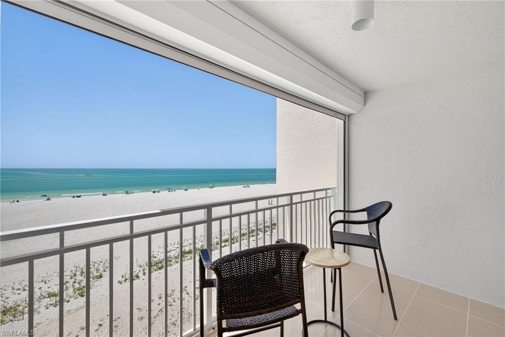 Balcony with view of water and beach