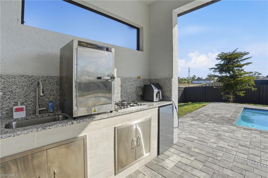 Fenced backyard with a patio area and area for grilling