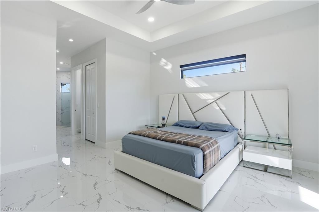 Bedroom with multiple windows, a closet, a ceiling fan, and recessed lighting