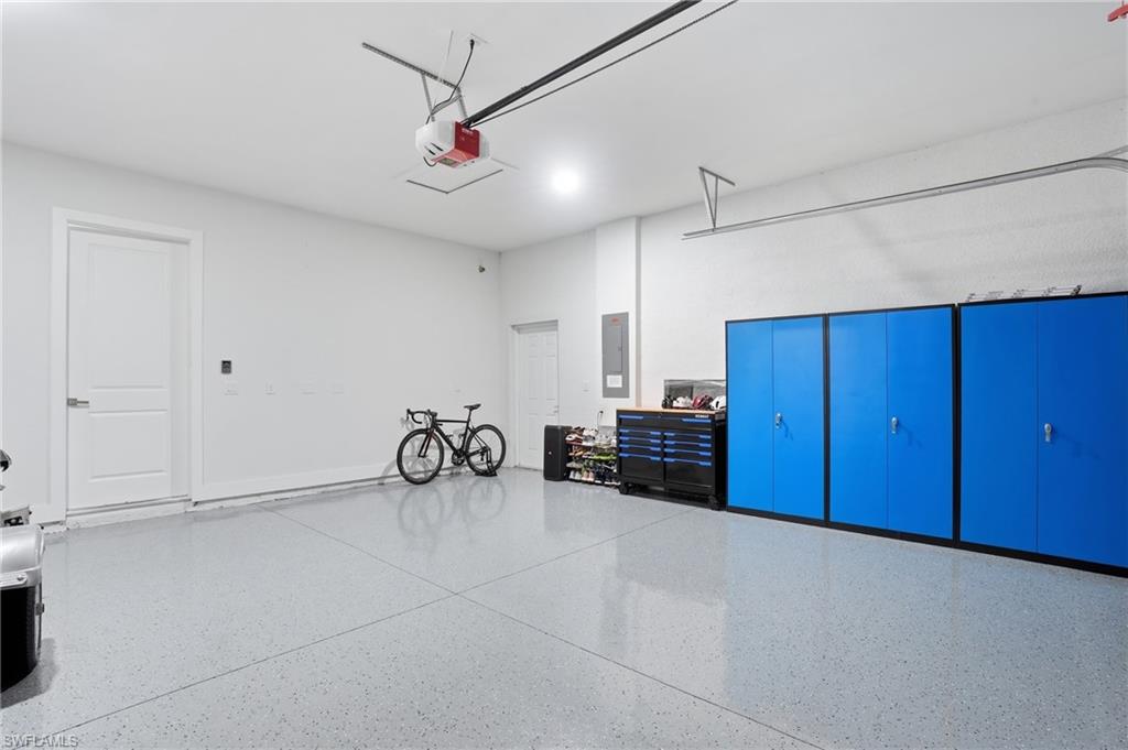 Garage with electric panel and a garage door opener