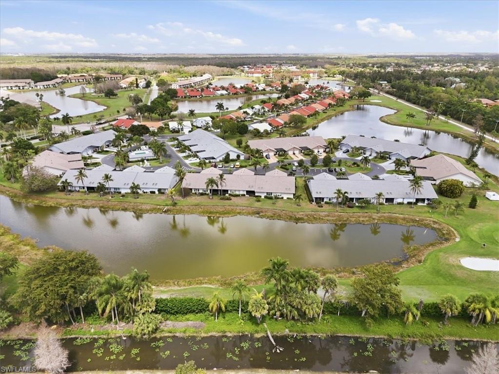 Aerial view of residential area featuring a large body of water and a local golf course