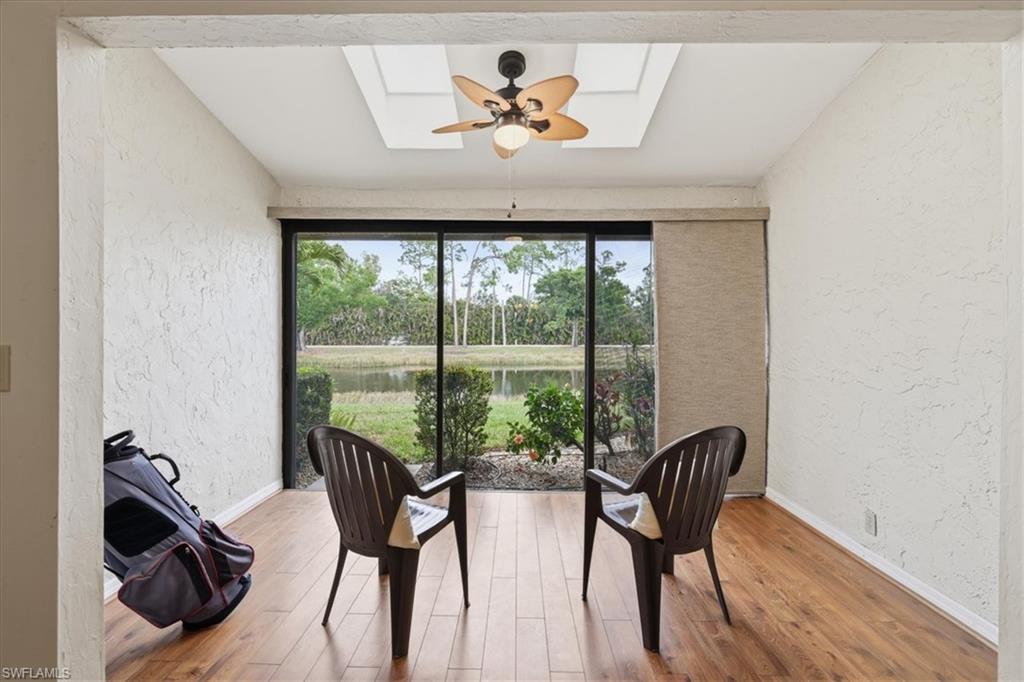 Sunroom / solarium with a skylight and a water view