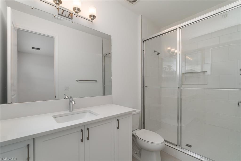 Bathroom with vanity and a shower stall