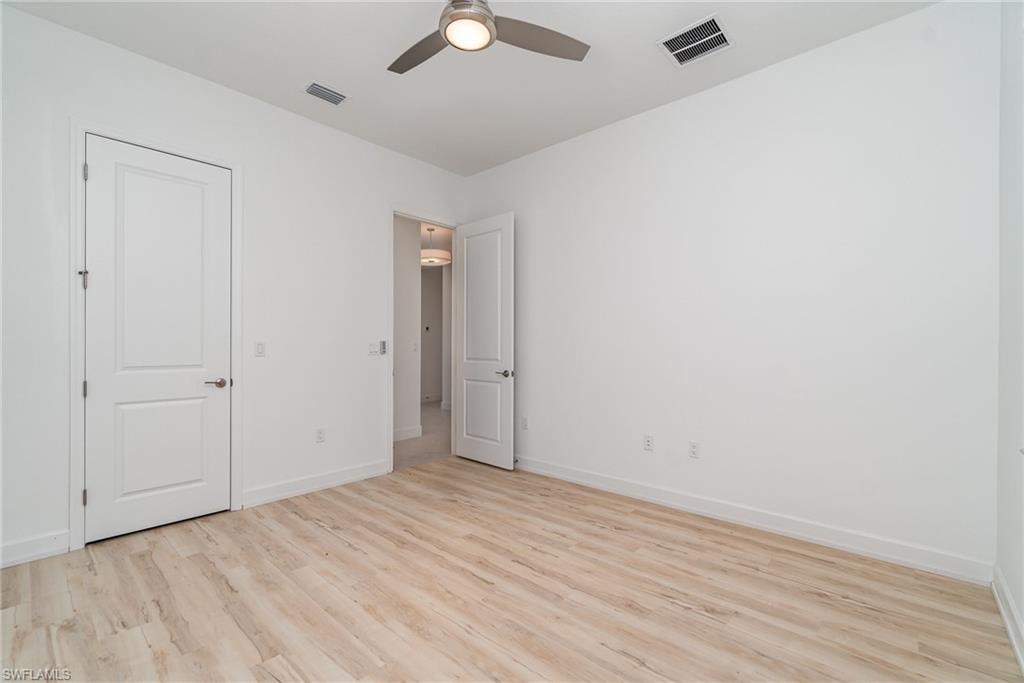 Unfurnished bedroom with light wood finished floors and a ceiling fan