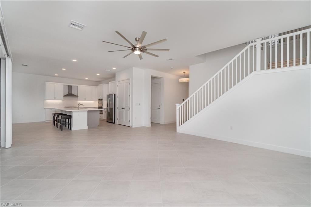 Unfurnished living room with recessed lighting, ceiling fan, and light tile patterned flooring