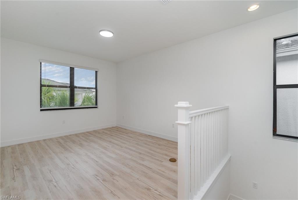 Spare room with light wood-type flooring and baseboards