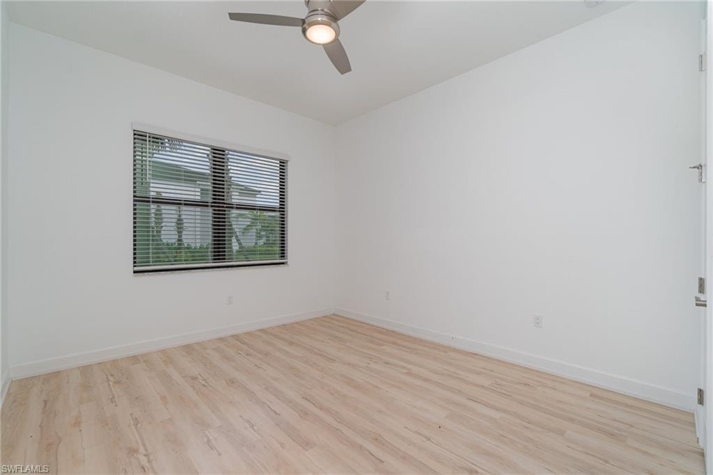 Empty room featuring light wood-style flooring and a ceiling fan