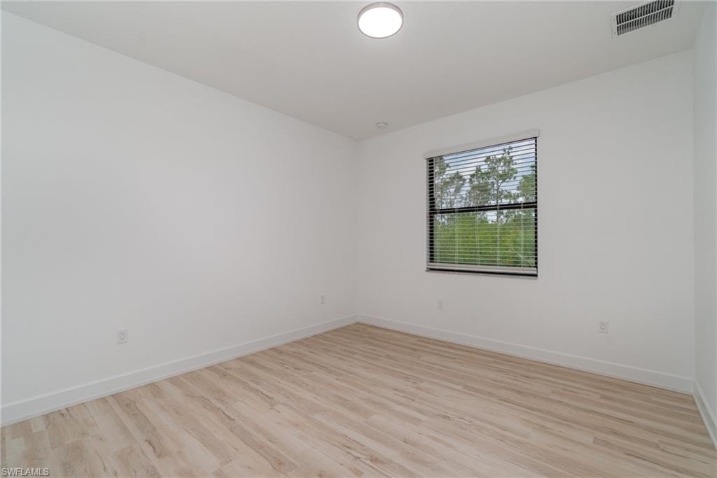 Empty room featuring light wood-type flooring and baseboards