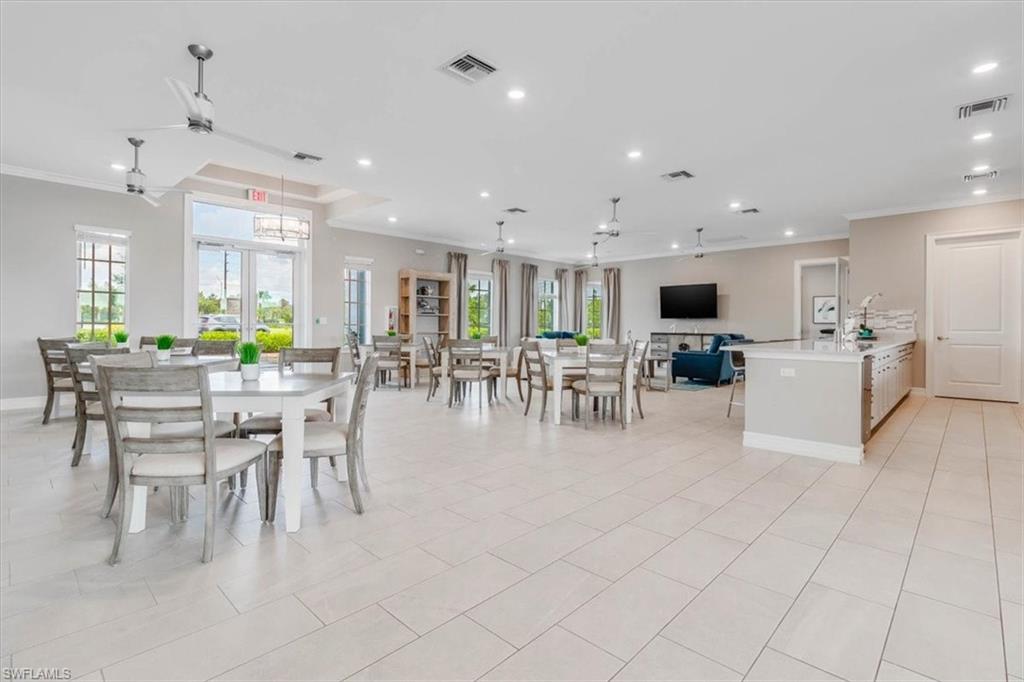 Dining area featuring ceiling fan, crown molding, recessed lighting, and light tile patterned flooring