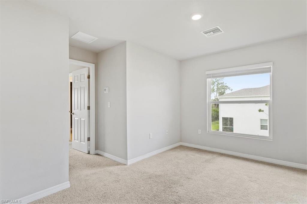 Unfurnished room featuring light colored carpet and recessed lighting