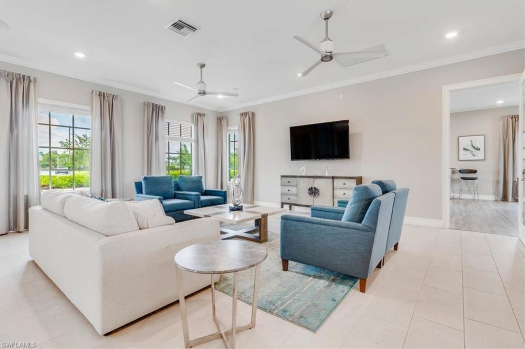 Living room featuring crown molding, a ceiling fan, and recessed lighting