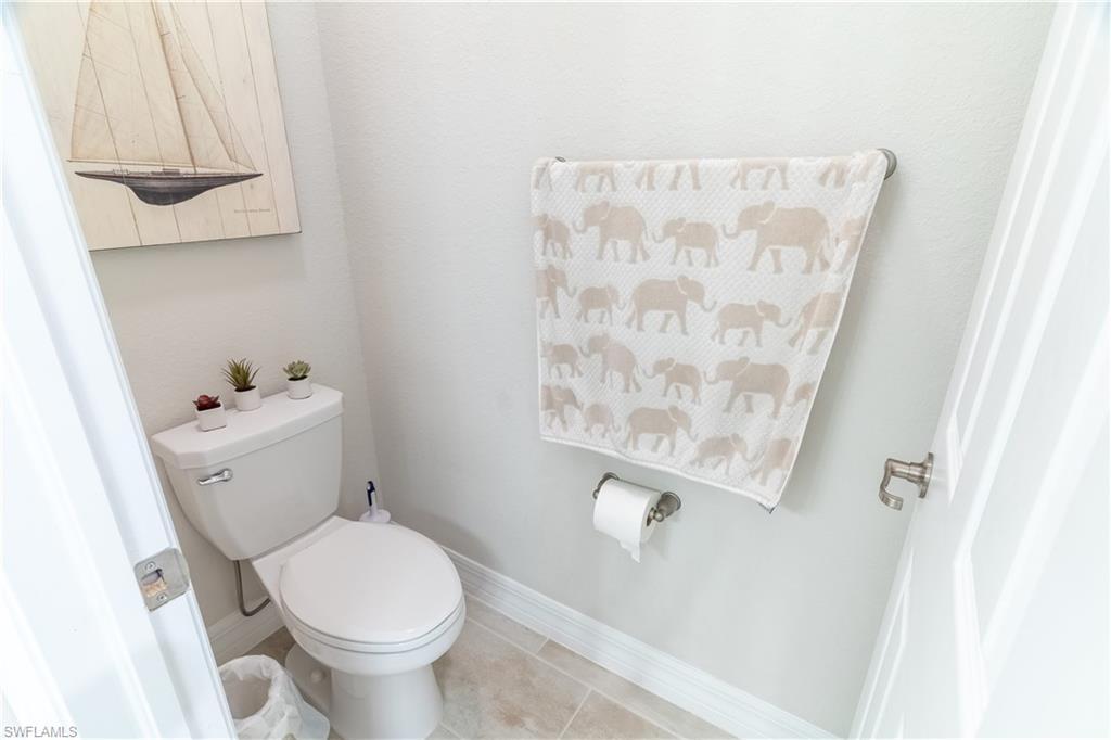 Bathroom featuring toilet and tile patterned flooring
