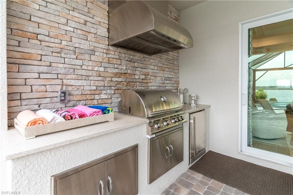 Kitchen featuring high quality fridge and range hood