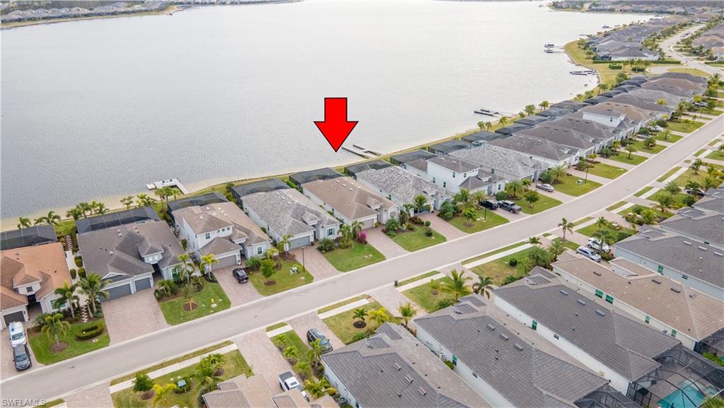 Birds eye view of property with a water view