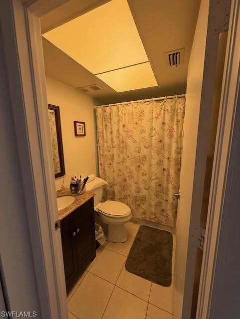 Bathroom featuring vanity, a shower with curtain, and light tile patterned flooring
