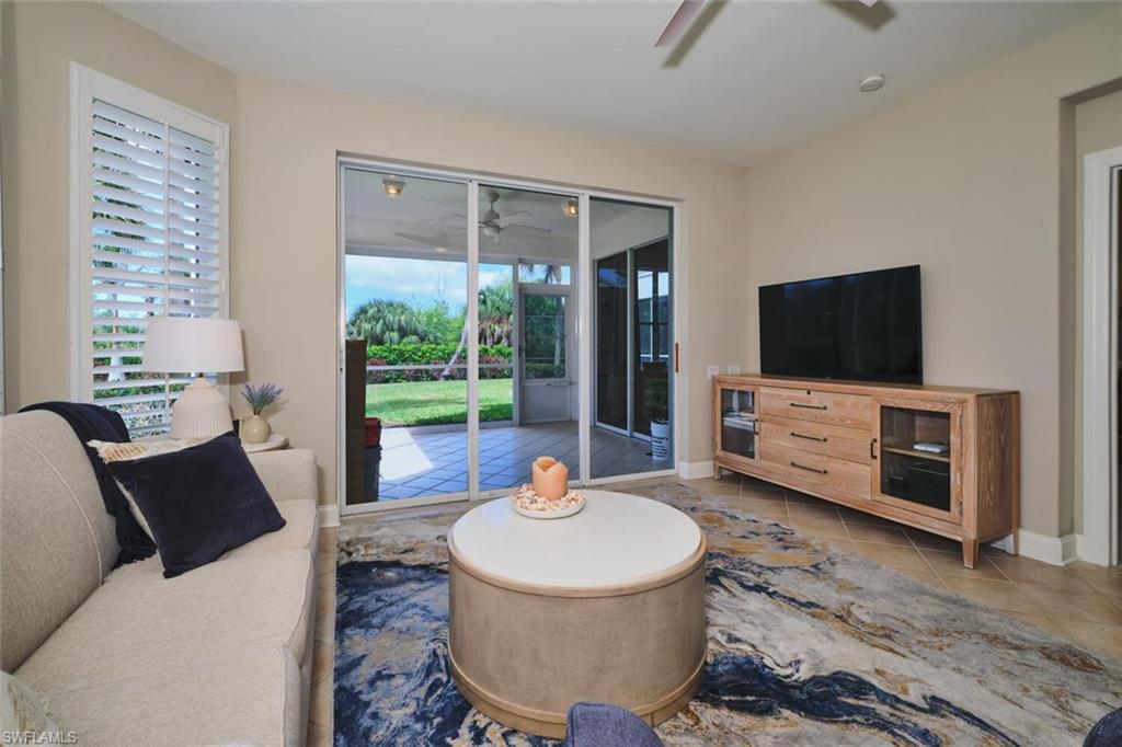 Living area with a ceiling fan and tile patterned floors