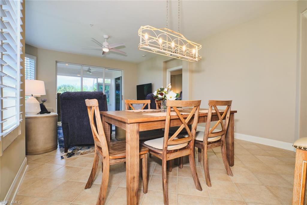 Dining space with light tile patterned floors and ceiling fan